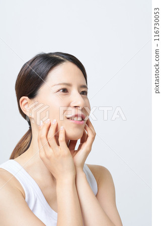 一位穿著背心的女士正在檢查她的皮膚狀況 一位穿著背心的女士正在檢查她的皮膚狀況 116730053