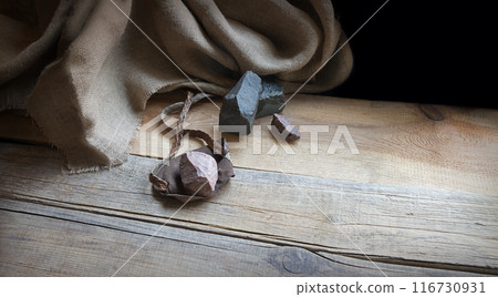 An antique leather sling lies on wooden desk 116730931