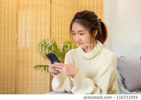 Woman embraces digital world from comfort of home. Woman embraces digital world from comfort of home. 116731059