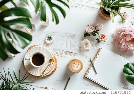 Top view white table with a cup of coffee, a notebook, and a potted plant. Cozy and relaxing atmosphere 116731955