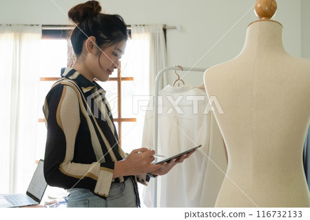 Young clothing designer working with tablet. 116732133
