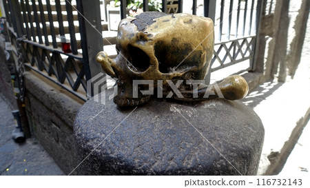 A lucky metal skull with crossbones on a stone. A lucky metal skull with crossbones on a stone. 116732143