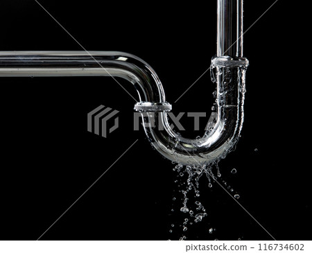 Drain leak water from pipe plumbing in bathroom as water clogged drop. Black background isolated. Leaking water from chromium stainless steel pipe under sink 116734602