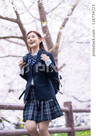 High school girls running under the cherry blossom trees 116734723