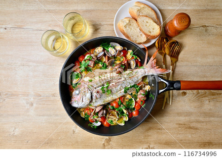 Red sea bream aquapazza, Italian cuisine, red sea bream, clams, cherry tomatoes, Italian parsley, white wine, bread. 116734996