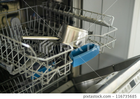 Dishwasher in modern kitchen. Perfectly washing pan. Modern built-in dishwasher with open door in the kitchen at home Dishwasher in modern kitchen. Perfectly washing pan. Modern built-in dishwasher with open door in the kitchen at home 116735685