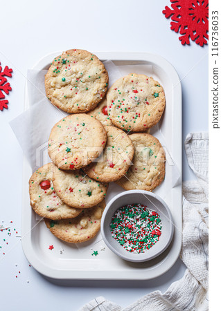 Christmas cookies with white chocolate and green-red sprinkles, white background. Christmas cookies with white chocolate and green-red sprinkles, white background. 116736033