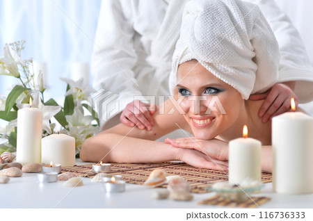 Beautiful woman in spa centar enjoying the massage. Beautiful woman in spa centar enjoying the massage. 116736333