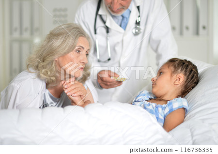 Little girl in the hospital with her grandmother and doctor Little girl in the hospital with her grandmother and doctor 116736335