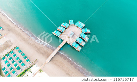 Immerse in the beauty of the turquoise ocean, admire overwater bungalows from above Immerse in the beauty of the turquoise ocean, admire overwater bungalows from above 116736717