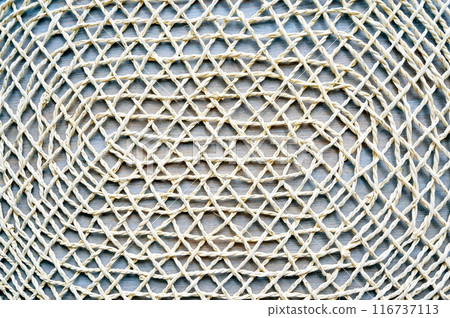Close-up of lace tablecloth background. Decorative handmade knitted cloth.Textured wooden textile table cover. 116737113