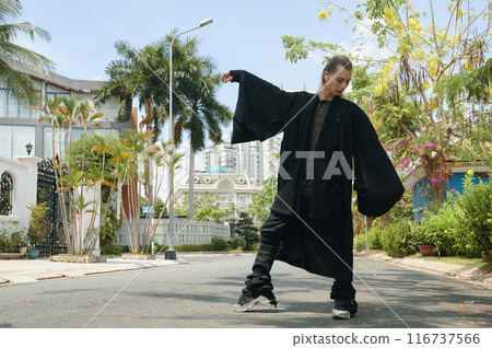 Fashion Model In Black Gown Outdoors 116737566
