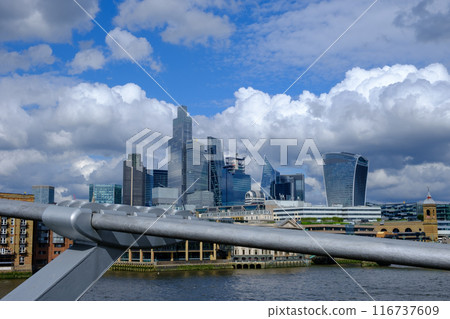 City of London business district Shiny Skyscrapers set against a dramatic stormy sky. 116737609