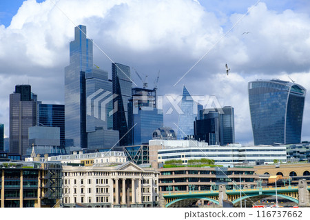 City of London business district Shiny Skyscrapers set against a dramatic stormy sky. City of London business district Shiny Skyscrapers set against a dramatic stormy sky. 116737662