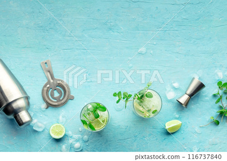 Mojito cocktail. Summer cold drink with lime, fresh mint, and ice. Cool beverage Mojito cocktail. Summer cold drink with lime, fresh mint, and ice. Cool beverage 116737840