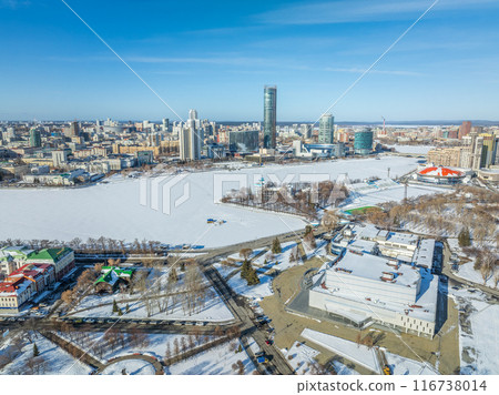 Yekaterinburg aerial panoramic view in Winter at sunset. Yekaterinburg city and pond in winter. Yekaterinburg aerial panoramic view in Winter at sunset. Yekaterinburg city and pond in winter. 116738014