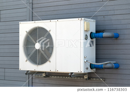 Condensing unit of air conditioning systems. Condensing unit installed on the gray wall. 116738303