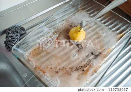 Minimalist kitchen cleaning scene with lemon. Natural cleaning, household maintenance. Concept of eco-friendly cleaning methods. Minimalist kitchen cleaning scene with lemon. Natural cleaning, household maintenance. Concept of eco-friendly cleaning methods. 116738927