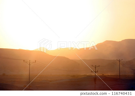 Sunset on the famous road number 90, which crosses Israel from north to south in the Jordan Valley, near the Dead Sea, Israel Sunset on the famous road number 90, which crosses Israel from north to south in the Jordan Valley, near the Dead Sea, Israel 116740431