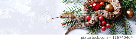 Festive Snake Among Christmas Decorations on Snowy Backdrop 116740464