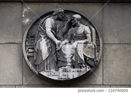 Marc Aurele heals by Galen. Stone relief at the building of the Faculte de Medicine Paris. Marc Aurele heals by Galen. Stone relief at the building of the Faculte de Medicine Paris. 116740809