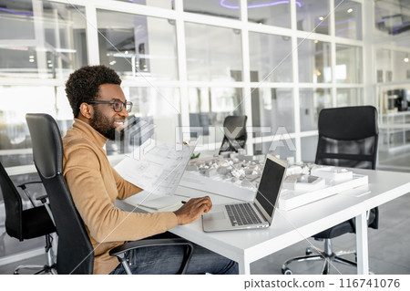 Experienced man architect designing houses in his modern office 116741076