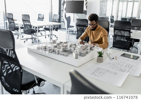 Talented man architect sketching plans in the office Talented man architect sketching plans in the office 116741078