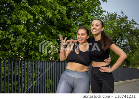 Two women in sports clothes standing on outdoors 116741231