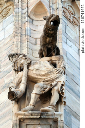 Detail of stone statue carving on the facade of the Milan Cathedral, Duomo di Santa Maria Nascente, Milan, Lombardy, Italy Detail of stone statue carving on the facade of the Milan Cathedral, Duomo di Santa Maria Nascente, Milan, Lombardy, Italy 116741651