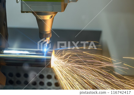 Close up scene the fiber laser cutting machine cut the stainless steel tube with the laser beam light. Close up scene the fiber laser cutting machine cut the stainless steel tube with the laser beam light. 116742417