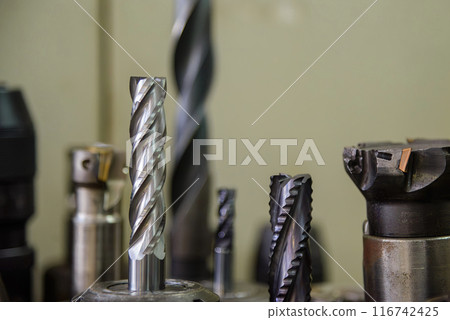 Close-up scene group of the used flat or square solid end mill tools. 116742425