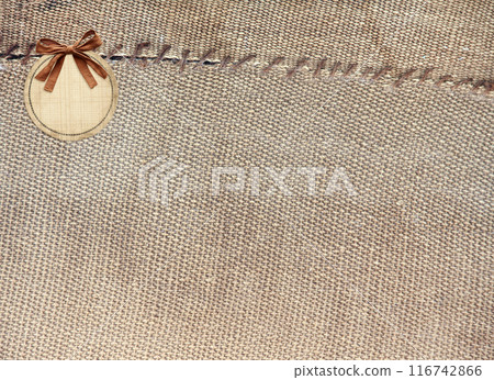 Two pieces of old burlap sewn together with thread. Horizontal background with rustic bag texture 116742866