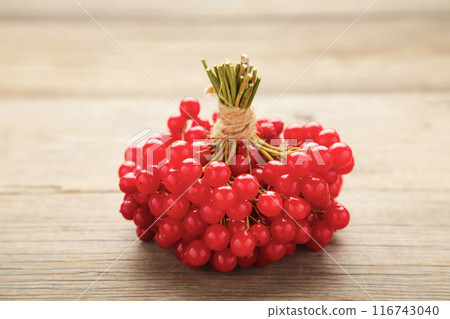 Red berries of viburnum on grey wooden background 116743040