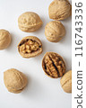 top view photo of walnuts in their shells on a white background 116743336