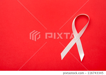 Pink satin breast cancer awareness ribbons on red background. Pink satin breast cancer awareness ribbons on red background. 116743345