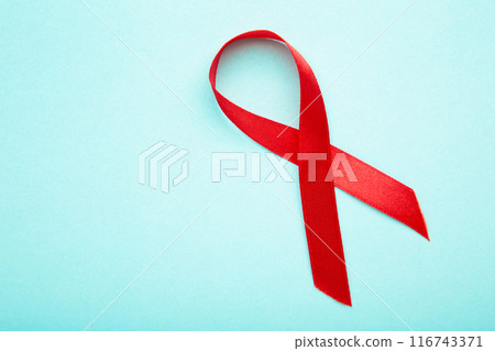 Aids awareness red ribbon on blue background 116743371