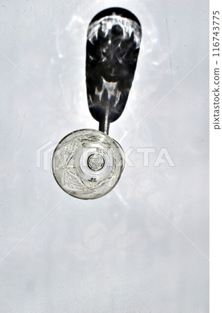 The shadow of a crystal glass on the table. The shadow of a crystal glass on the table. 116743775