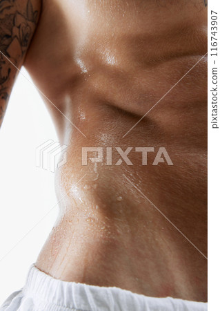 Cropped close-up image of athletic male sweating body, relief, muscular strong body, torso. Aesthetics of sportive male body Cropped close-up image of athletic male sweating body, relief, muscular strong body, torso. Aesthetics of sportive male body 116743907