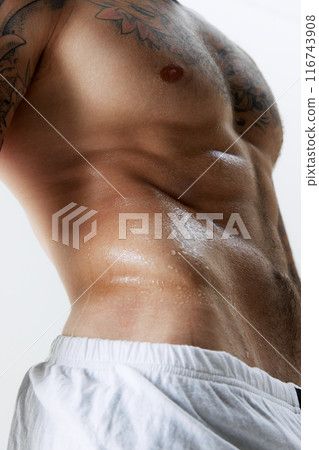 Cropped image of athletic male sweating body, relief, muscular strong body, torso , male model posing in underwear isolated on white studio background 116743908