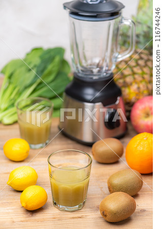 Green smoothie made with a blender, vegetables and fruits Green smoothie made with a blender, vegetables and fruits 116744246