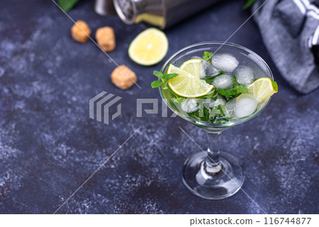 Martini cocktail with lime and mint. 116744877
