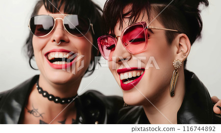 Two Women Wearing Sunglasses and Smiling 116744892