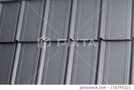 Close-up view lightweight galvanised steel roofing sheet. Modular tile effect roof panel. Traditional metal shingle tiles. Popular profiled metallic pantile mimic clay or concrete slate Close-up view lightweight galvanised steel roofing sheet. Modular tile effect roof panel. Traditional metal shingle tiles. Popular profiled metallic pantile mimic clay or concrete slate 116745321