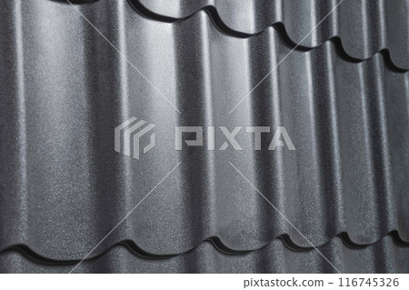 Close-up view lightweight galvanised steel roofing sheet. Modular tile effect roof panel. Traditional metal shingle tiles. Popular profiled metallic pantile mimic clay or concrete slate 116745326
