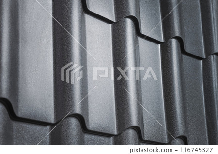 Close-up view lightweight galvanised steel roofing sheet. Modular tile effect roof panel. Traditional metal shingle tiles. Popular profiled metallic pantile mimic clay or concrete slate 116745327
