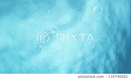 Freeze motion of splashing water surface on light blue background Freeze motion of splashing water surface on light blue background 116746082
