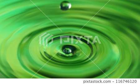 Freeze motion of splashing water drop on on light green background 116746120