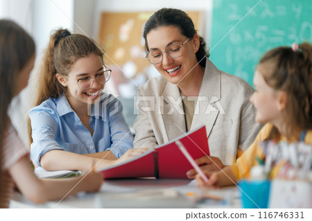 Happy kids and teacher at school 116746331