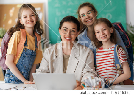 Happy kids and teacher at school 116746333