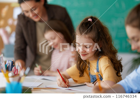 Happy kids and teacher at school 116746334
